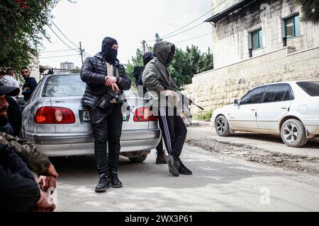 Jénine, Palestine. 27 mars 2024. Des hommes armés participent aux funérailles de 3 jeunes Palestiniens tués par les balles des forces israéliennes lors d'un raid sur le quartier de Damj dans le camp de Djénine en Cisjordanie occupée. Crédit : SOPA images Limited/Alamy Live News Banque D'Images