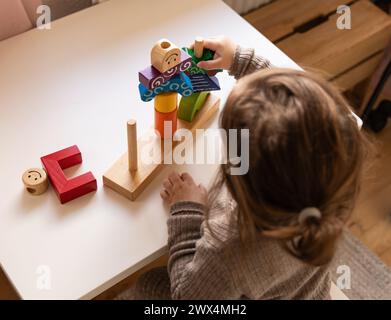 Enfant jouant à un jeu amusant de logique avec des blocs de bois colorés. Jour et nuit jeu de logique. Jeux éducatifs pour les enfants et se développent plus tôt Banque D'Images