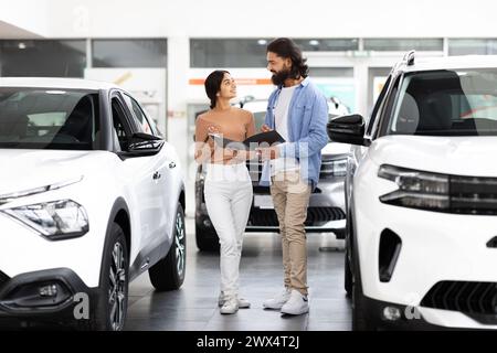 Couple envisageant une voiture en concession Banque D'Images