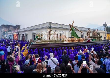 Antigua, Guatemala. 27 mars 2024. Les Costaleros transportent l’énorme flotteur processionnel Jesús Nazareno del Milagro dans les rues pendant la traditionnelle Santa Semana célébrant la semaine Sainte, le 27 mars 2024 à Antigua, Guatemala. Les processions opulentes, les algèbres détaillées et les traditions séculaires attirent plus d'un million de personnes dans l'ancienne capitale. Crédit : Richard Ellis/Richard Ellis/Alamy Live News Banque D'Images