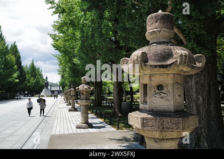 Lanternes de pierre traditionnelles sur le Sando, la route approchant le Yasukuni Shrine.Tokyo.Japan Banque D'Images