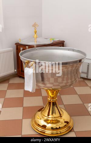 Baptême font avec de l'eau avec serviette dans une église orthodoxe. L'intérieur de la salle pour le baptême des enfants dans l'Église orthodoxe. Banque D'Images