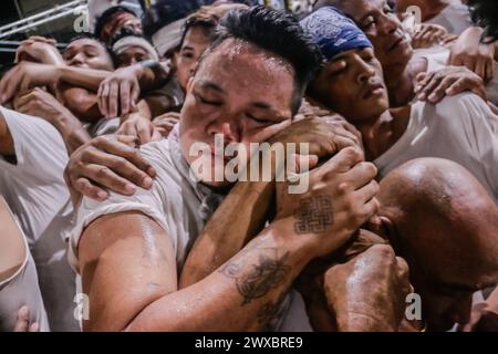 29 mars 2024, Binangonan, Rizal, Philippines : les dévots catholiques luttent pour manœuvrer le transport de Jésus mort à Binangonan, Rizal le vendredi Saint, 29 mars 2024. Le gewang-gewang, un mot tagalog qui se traduit par ''balancement'' en anglais, est une tradition du vendredi Saint où la plupart des hommes sont les participants. Cette vénérable tradition se concentre sur le transport du Santo Entierro ou l'icône morte de Jésus de sa maison particulière à une église tandis qu'à l'intérieur du chariot de cercueil en verre transporté principalement par des hommes dévoués pendant la procession qui est semblable au Traslacion du Nazaréen noir de Banque D'Images