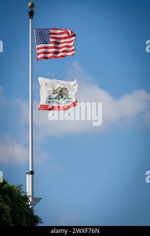 Les drapeaux des États-Unis et de l'État de Californie flottent un jour venteux à partir d'un mât de drapeau dans la vieille ville de San Diego, en Californie. Banque D'Images