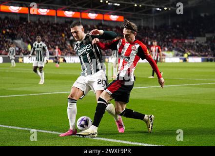 Diogo Dalot de Manchester United (à gauche) et Mathias Jensen de Brentford s'affrontent pour le ballon lors du match de premier League au Gtech Community Stadium de Londres. Date de la photo : samedi 30 mars 2024. Banque D'Images