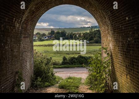 Campagne encadrée par un tunnel de briques sous le pont Banque D'Images