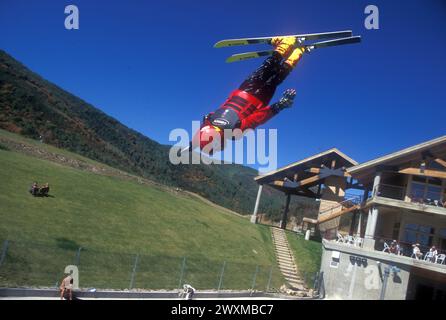 Un jeune sauteur à ski freestyle (adolescent) atterrit dans une piscine à partir d'une rampe spécialement construite au centre d'entraînement olympique de Park City, Utah - la piscine brise l'automne pour ces newcom Banque D'Images