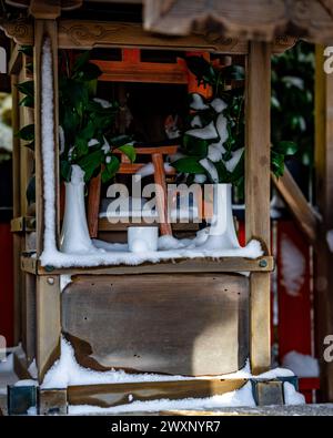 Un petit sanctuaire shinto bouddhiste couvert de neige à Kyoto au Japon. Banque D'Images