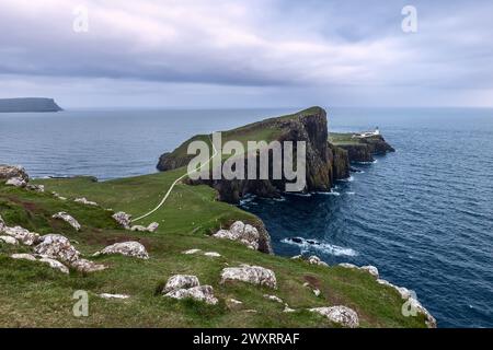 Le phare de Neist point, perché à flanc de falaise, est un phare de solitude contre la vaste étendue de la mer Banque D'Images