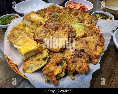 Jeon, un fritter dans la cuisine coréenne fait en assaisonnant du poisson entier, tranché ou haché, de la viande, des légumes, etc, et les enduire de farine de blé et d'oeuf w Banque D'Images