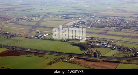 Vue aérienne de la RAF Leeming regardant vers l'est à travers l'A1(M) avec le village de Londonderry au premier plan Banque D'Images