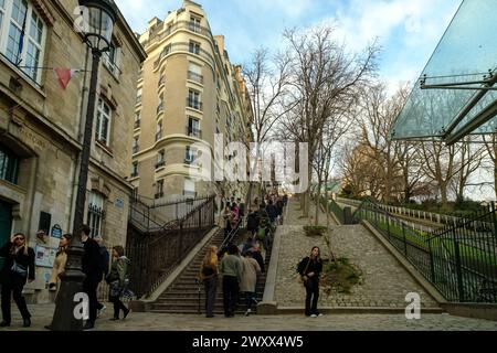 Paris, France - 17 février 2024 : vue panoramique des touristes qui montent et descendent les escaliers pittoresques à côté d'un funiculaire de Montmartre Paris Banque D'Images