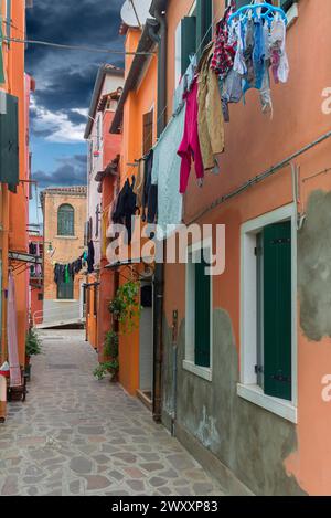 Maisons colorées avec buanderie en ligne dans une ruelle sur Burano, Venise, Vénétie, Italie Banque D'Images