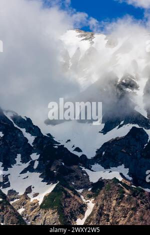 Nuages et neige sur l'imposant Mont Hotakadake dans la chaîne de montagnes Hida dans les Alpes japonaises du nord Banque D'Images