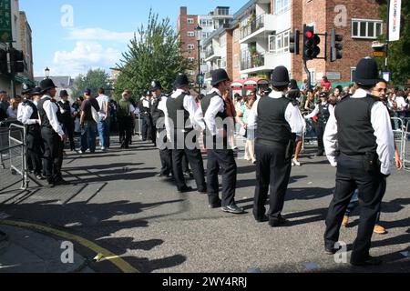 Londres, Angleterre - août 28 2006 : des policiers vérifient la foule pendant le carnaval de Notting Hill. Banque D'Images