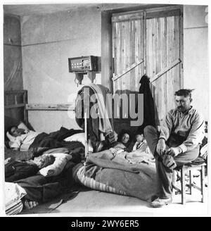 Une FAMILLE FRANÇAISE RETOURNE DANS LEUR VILLAGE DÉCHIRÉ DE COQUILLAGES - après une dure journée de nettoyage de l'une des pièces de leur nouvelle maison, et de récupérer quels biens ils pourraient la famille se retirer au lit. , Armée britannique, 21e groupe d'armées Banque D'Images