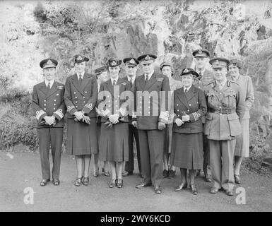 SAR LA DUCHESSE DE KENT, PRÉSIDENTE DU WRNS VISITE DES ÉTABLISSEMENTS NAVALS. 1940. - Groupe pris à Admiralty House, Rosyth. De gauche à droite : première rangée : le contre-amiral Cantlie ; Lady Mary Herbert ; SAR la duchesse de Kent ; le vice-amiral Sir Gordon Ramsey ; Mlle Mackenzie Grieve, surintendante de la WRNS ; Lord Elgin. Rangée arrière : Mme Breese ; capitaine de corvette Gairdner ; Lady Elgin ; vice-maréchal de l'air Breeze ; Mme Cantile. , Cantlie, Colin, Marina, Princesse (Duchesse de Kent), Ramsey, Charles Gordon, Grieve, Muriel Eva Mackenzie-, Bruce, Edward James (10e comte d'Elgin), Bruce, Katherine Elizabeth (Lady E Banque D'Images