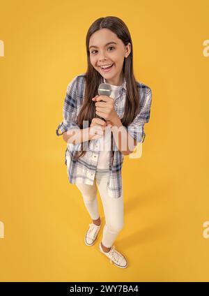 photo de souriant teen girl chanteur de karaoké avec microphone. chanteuse de karaoké adolescente Banque D'Images