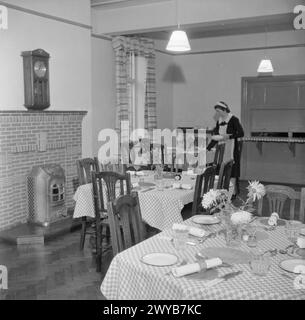 FORMATION QUEEN'S NURSES : FORMATION D'INFIRMIÈRES DE DISTRICT À L'INSTITUT QUEEN'S DES SOINS INFIRMIERS DE DISTRICT, GUILDFORD, SURREY, ANGLETERRE, ROYAUME-UNI, 1944 - Une femme de ménage prépare les tables pour le déjeuner dans la salle à manger agréablement meublée de la maison des infirmières du Queen's Institute of District Nursing, Guildford. , Banque D'Images