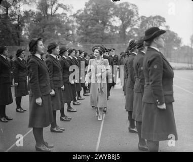 SA MAJESTÉ LA REINE INSPECTE WRENS. 11 MAI 1942, MANOIR DEDWORTH, WINDSOR. LA REINE A INSPECTÉ WRENS DU BUREAU DE PAYE DE LA MARINE. - Sa Majesté inspectant le WRNS pendant sa visite. Les membres du Women's Royal Naval Service (WRNS) étaient familièrement connus sous le nom de Wrens. Les Wrens de Dedworth Manor faisaient partie du complément d'un établissement à terre de la Royal Navy, nommé HMS President III. L'établissement était responsable de la paye, des comptes et de l'administration du personnel qui servait à bord de navires marchands équipés de moyens défensifs (DEMS). , Banque D'Images