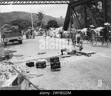 LA SECONDE GUERRE MONDIALE 1939 - 1945 : LA GUERRE EN EXTRÊME-ORIENT 1941 - 1945 - les ingénieurs royaux se préparent à faire sauter un pont en Malaisie lors de la retraite britannique à Singapour, décembre 1941. En arrière-plan, des rickshaws chinois chargés de riz provenant de stocks gouvernementaux abandonnés traversent le pont. Les forces alliées commandées par le général Arthur Percival se rendent au général Yamashita à Singapour le 15 février 1942 après une campagne japonaise en Malaisie de près de 70 jours. , Armée britannique, Royal Engineers Banque D'Images