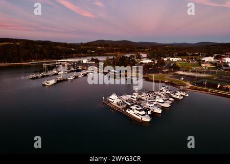 Un magnifique coucher de soleil rose sur le port de Sainte-Hélène en Tasmanie avec des bateaux amarrés sur des eaux calmes. Banque D'Images