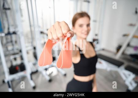 Femme tient des bandes élastiques pour la forme physique dans sa main Banque D'Images
