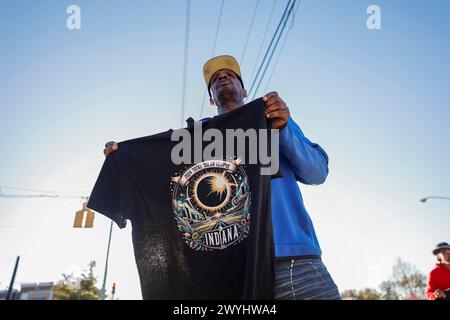 Bloomington, États-Unis. 06 avril 2024. Un vendeur vend des t-shirts Indiana Eclipse à l'angle de North Walnut et de 17th Street à Bloomington. Des milliers de personnes sont attendues à Bloomington, qui est sur le chemin de l’éclipse solaire totale de 2024 qui aura lieu lundi 8 avril 2024. Le vendeur a dit qu'il serait au même endroit à partir de 7 heures lundi, et tout le week-end. Crédit : SOPA images Limited/Alamy Live News Banque D'Images