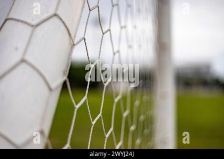 Fond de football ou de filet de football. Vue de derrière le but avec stade et terrain flous. Banque D'Images