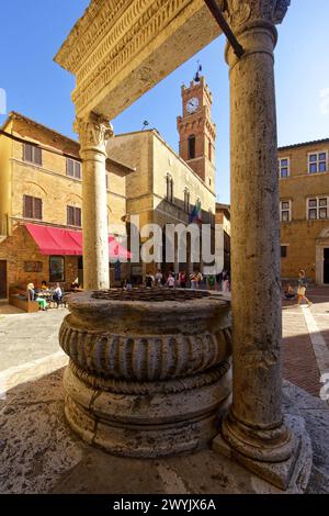 Italie, Toscane, Val d'Orcia, classé au patrimoine mondial de l'UNESCO, Pienza, Piazza Pio II, le puits et le Palazzo Comunale Banque D'Images