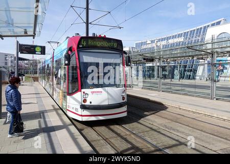 27.03.2024, Erfurt, Thueringen, GER - Strassenbahn der Linie 4 vor dem terminal des Flughafen Erfurt-Weimar. Alltag, aussen, Aussenaufnahme, Bahn, Befoerderung, deutsch, Deutschland, Erfurt, Europa, europaeisch, Fahrgast, Flughafen, Flughafen Erfurt-Weimar, Flughafengebaeude, Frau, Fruehjahr, Fruehling, Gebaeude, Gesellschaft, Individualverkehr, Jahreszeit, Linie 4, Mensch, Nahverkehr, oeffentlicher Personennahverkehr, OEPNV, Personenbefoerderung, Personentransport, Personenverkehr, QF, Querformat, Schiene, Schienenverkehr, Stadt, Stadtansicht, Stadtbahn, Stadtbild, Stadtverkehr, Stras Banque D'Images