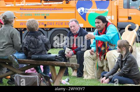 15.05.2012, Deutschland, Saxe, Dresde, Augustusbrücke, Neustädter Elbseite, Elbwiesen, der Schauspieler und Schirmherr der Karl-May-Festspiele Radebeul Peter Sodann roter Pullover und Murray Small Legs, Blackfoot-Indianer aus Kanada hellblaue Jacke, lesen Kindergartenkindern zur Einstimmung auf die Karl-May-Festtage in Radebeul Geschichten vor *** 15 05 2012, Allemagne, Saxe, Dresden, Augustusbrücke Neustädter Elbseite, Elbwiesen, acteur et patron du Karl May Festival Radebeul Peter Sodann chandail rouge et Murray Small Legs, Indien Blackfoot du Canada blouson bleu clair , lire STO Banque D'Images