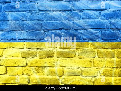 Un drapeau bleu et jaune est peint sur un mur de briques. Le drapeau est peint sur le mur d'une manière telle qu'il semble flotter Banque D'Images