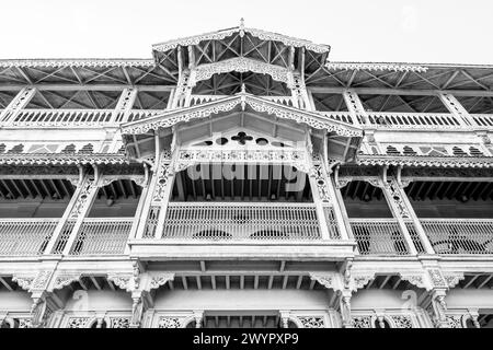 Image en noir et blanc des balcons en bois complexes de l'ancien dispensaire colonial de Stone Town, Zanzibar, Tanzanie. Banque D'Images