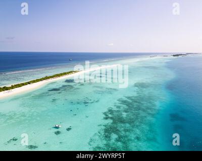 Vue aérienne de l'île de Dhigurah aux Maldives célèbre pour sa longue plage de sable blanc bordée de palmiers dans l'atoll sud d'Ari Banque D'Images