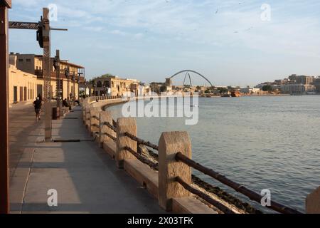 Vue de l'autre côté de la crique du quartier historique d'Al Shindagha vers le pont de l'infini à Bur Dubai, Émirats arabes Unis. Banque D'Images