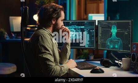 Homme insérant un disque dans un PC contenant un logiciel transformant l'IA en être conscient de soi sensible, saluant le créateur. Ingénieur plaçant la cartouche dans l'ordinateur, éveillant l'intelligence artificielle amicale, caméra A. Banque D'Images