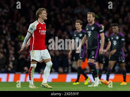 Londres, Royaume-Uni. 10 avril 2024. Martin Odegaard d'Arsenal (1er l) célèbre un but alors que Harry Kane (3e l) du Bayern Munich semble abattu lors du match de quart de finale de la 1ère manche de l'UEFA Champions League entre le Bayern Munich et Arsenal à Londres, Grande-Bretagne, le 9 avril 2024. Crédit : Xinhua/Alamy Live News Banque D'Images