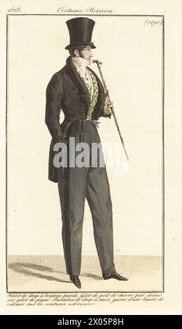 French Dandy en chapeau haut de gamme, gilet avec boutons assortis, gilet de laine, pantalon rayé avec bande de velours sur la couture extérieure, tenant une canne. Habit de drap a boutons pareils, gilet de poil de chevre par dessus un gilet de pique, pantalon de drap a raies, garni d'une bande de velours sur les coutures exterieurs. Gravure sur cuivre colorée à la main d’après une plaque mode de Louis Marie Lante du Journal des Dames et des modes de Pierre de la Mesangère, Magazine of Women and Fashion, Paris, 1823. Banque D'Images