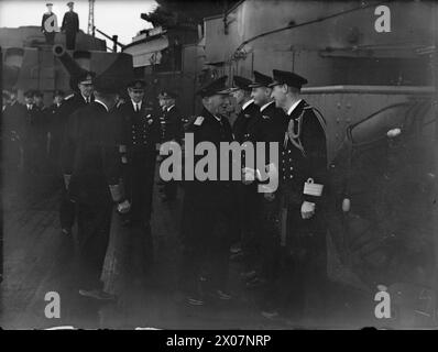 LE COMMANDANT EN CHEF DE LA FLOTTE HOME QUITTE SON POSTE. DÉCEMBRE 1940, À BORD DU NAVIRE AMIRAL HMS NELSON. AMIRAL DE LA FLOTTE SIR CHARLES FORBES, ABANDONNANT SON POSTE DE C DANS C HOME FLEET POUR PRENDRE LE COMMANDEMENT DE C DANS C PLYMOUTH. L'AMIRAL JOHN CRONYN TOVEY SUCCÈDE À L'AMIRAL FORBES. - L'amiral J C Tovey, CB, DSO, nouveau C en C Home Fleet serre la main de ses officiers à son arrivée dans le HMS NELSON Banque D'Images