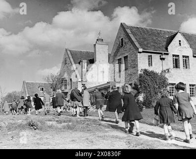 COLONIE POUR ARTISTES DE MOINS DE SIX ans : ÉVACUÉS À DARTINGTON HALL, TOTNES, DEVON, ANGLETERRE, 1941 - Un groupe d'enfants évacués de Londres et du Kent, à pied à l'école par deux au soleil. Ils séjournent à Dartington Hall, près de Totnes dans le Devon Banque D'Images