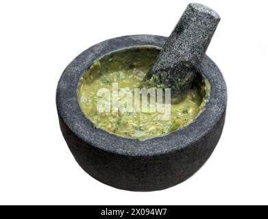 guacamole à l'intérieur molcajete (mortier mexicain traditionnel et pilon pour moudre les épices) trempette d'avocat isolé sur fond blanc, découpé Banque D'Images