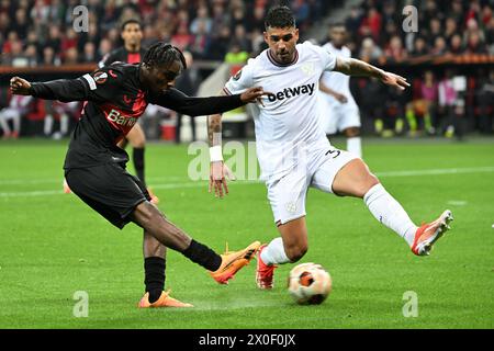 Leverkusen, Allemagne. 11 avril 2024. JEREMIE Frimpong (G) du Bayer 04 Leverkusen tente de tirer lors du match de première manche de l'UEFA Europa League entre le Bayer 04 Leverkusen et le West Ham United FC à Leverkusen, en Allemagne, le 11 avril 2024. Crédit : Ulrich Hufnagel/Xinhua/Alamy Live News Banque D'Images