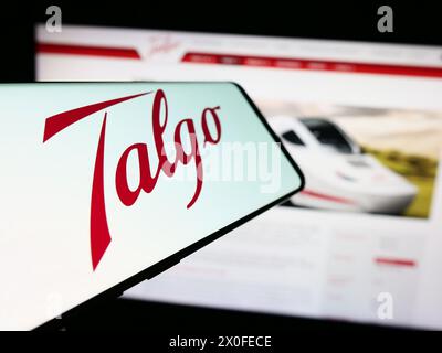 Téléphone portable avec logo de la société espagnole de fabrication de trains Talgo S.A. en face du site Web de l'entreprise. Mettez l'accent sur le centre-gauche de l'écran du téléphone. Banque D'Images