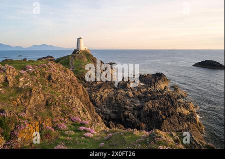 Le majestueux phare de TWR Mawr au coucher du soleil sur l'île de Ynys Llanddwyn à Anglesey, au nord du pays de Galles. Banque D'Images