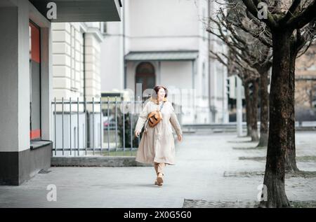 Femme élégante profitant d'une promenade tranquille dans la ville Banque D'Images