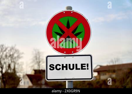 12 avril 2024 : panneau d'interdiction du cannabis devant une école. Signe avec une feuille de cannabis barrée et l'inscription : école. PHOTOMONTAGE *** cannabis Verbotsschild vor einer Schule. Schild mit durchgestrichenem Hanfblatt und der Aufschrift : Schule. FOTOMONTAGE Banque D'Images