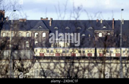 En arrière-plan se trouve l'hôpital CharitÃ© avec ses bâtiments anciens. Le train circule sur les arches de Stadtbahn, le mur passe derrière le S-Bahn. Les autres barrières sont en face des arcs Stadtbahn. [traduction automatique] Banque D'Images