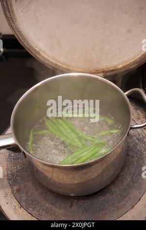 Haricots verts bouillant sur un four aga Banque D'Images