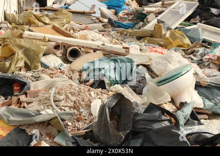 Plongez dans le paysage obsédant de la décomposition urbaine et de la dégradation de l'environnement avec cette image frappante d'une montagne de déchets dans une usine abandonnée Banque D'Images